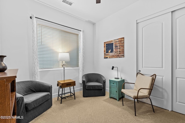 sitting room with carpet, visible vents, and baseboards