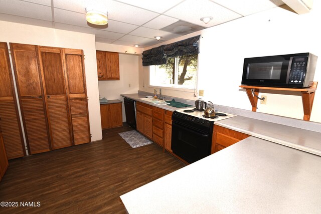 733 S 3rd St, Williams, AZ 86046 - kitchen with black appliances, brown cabinets, a sink, dark wood-type flooring, and a drop ceiling
