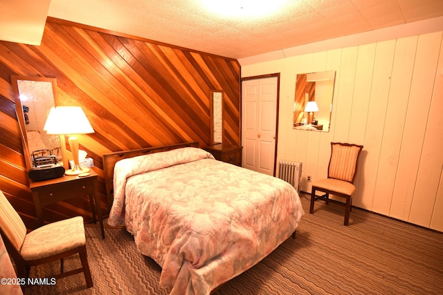 733 S 3rd St, Williams, AZ 86046 - carpeted bedroom featuring radiator and wooden walls