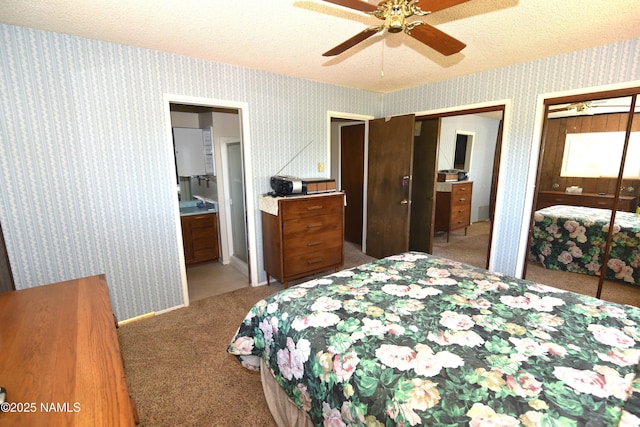 733 S 3rd St, Williams, AZ 86046 - bedroom with light colored carpet, multiple closets, wallpapered walls, a textured ceiling, and ensuite bath