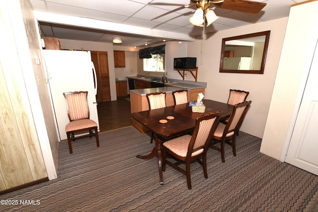 733 S 3rd St, Williams, AZ 86046 - dining room with dark carpet and a ceiling fan