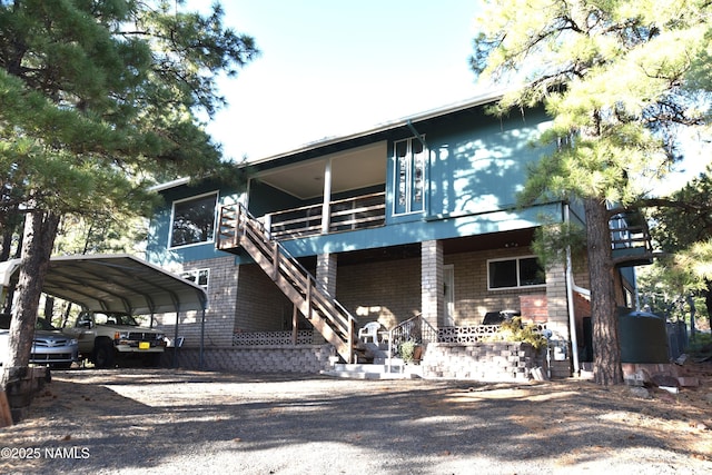 733 S 3rd St, Williams, AZ 86046 - view of front of house featuring driveway, a carport, and stairway