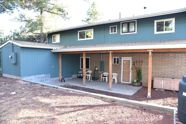 733 S 3rd St, Williams, AZ 86046 - back of house featuring a patio area, electric panel, and a shingled roof
