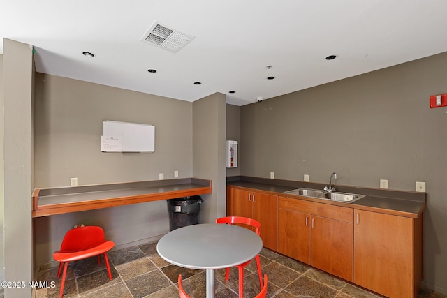 1385 W University Ave Unit 194, Flagstaff, AZ 86001 - kitchen featuring dark countertops, recessed lighting, and brown cabinets