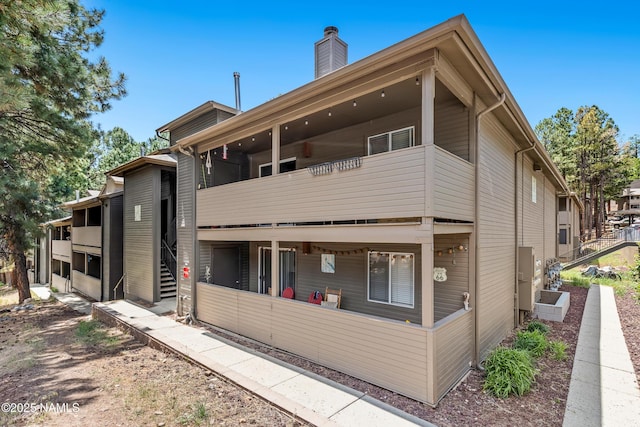 1385 W University Ave Unit 194, Flagstaff, AZ 86001 - back of house featuring a balcony and a chimney