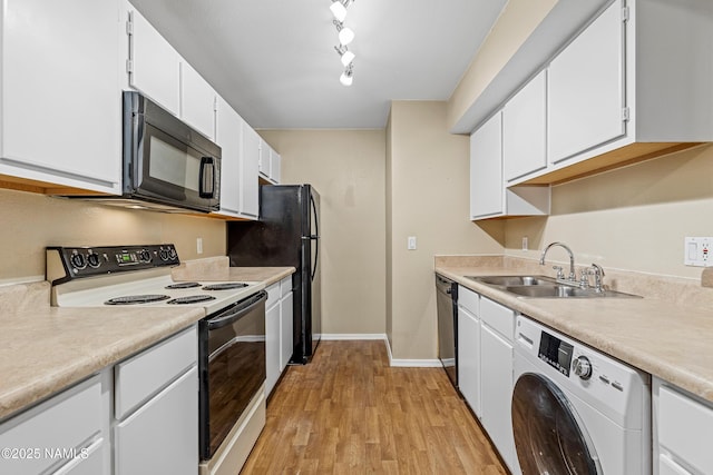 1385 W University Ave Unit 194, Flagstaff, AZ 86001 - kitchen with washer / dryer, black appliances, light wood finished floors, and white cabinets