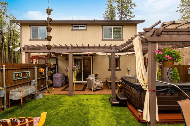 2749 Adirondack Ave, Flagstaff, AZ 86001 - rear view of house featuring a deck, a hot tub, a lawn, and a pergola