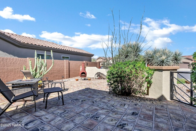 41215 N Lytham Ct, Phoenix, AZ 85086 - fenced backyard featuring a patio area, a fire pit, and a gate