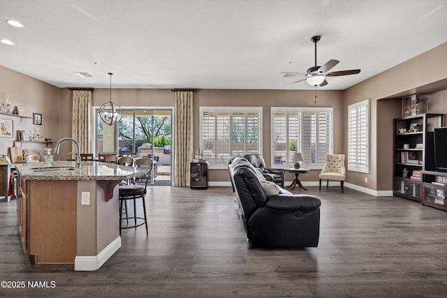 41215 N Lytham Ct, Phoenix, AZ 85086 - living area featuring ceiling fan, dark wood-type flooring, baseboards, recessed lighting, and a chandelier