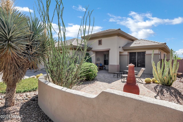 41215 N Lytham Ct, Phoenix, AZ 85086 - back of house featuring stucco siding and a patio area