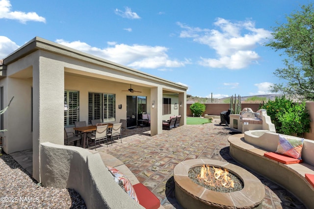 41215 N Lytham Ct, Phoenix, AZ 85086 - fenced backyard with an outdoor living space with a fire pit, ceiling fan, a patio area, and outdoor dining space