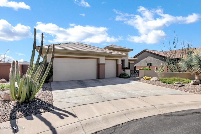 41215 N Lytham Ct, Phoenix, AZ 85086 - view of front of home featuring a garage, driveway, stucco siding, and a tile roof