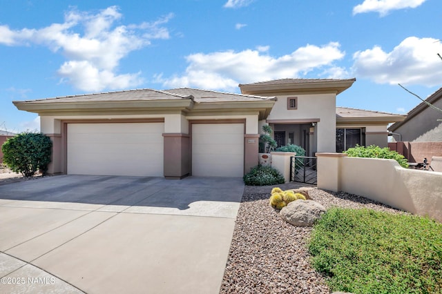 41215 N Lytham Ct, Phoenix, AZ 85086 - prairie-style house featuring a garage, driveway, stucco siding, and a gate