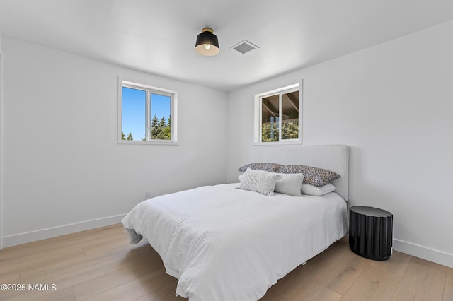 535 Stringer Rd, Munds Park, AZ 86017 - bedroom with multiple windows and wood finished floors