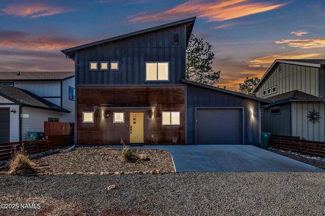 3580 Huron, Flagstaff, AZ 86005 - contemporary house with fence, an attached garage, board and batten siding, and concrete driveway