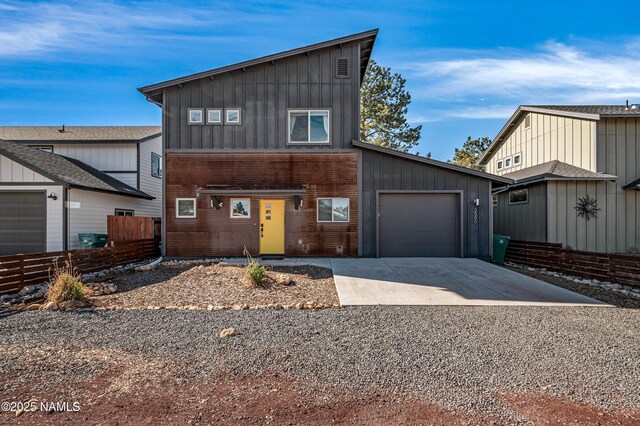 3580 Huron, Flagstaff, AZ 86005 - contemporary house featuring a garage, fence, board and batten siding, and concrete driveway