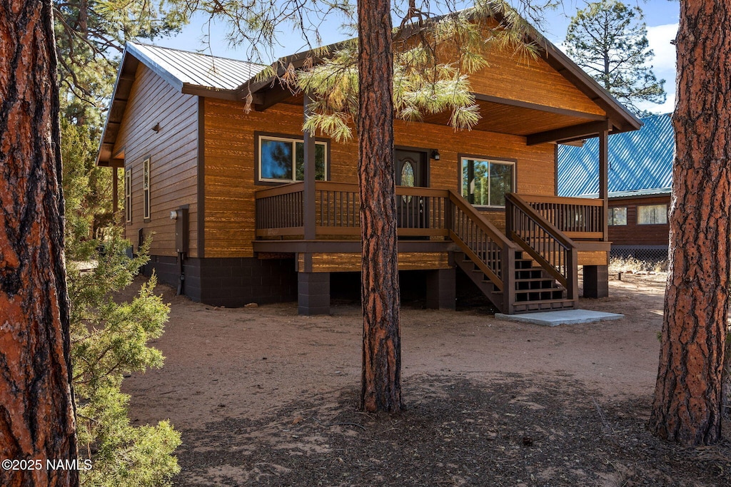 back of house featuring a wooden deck