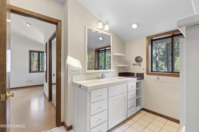 5241 E Mount Pleasant Dr, Flagstaff, AZ 86004 - bathroom with vaulted ceiling, baseboards, and vanity