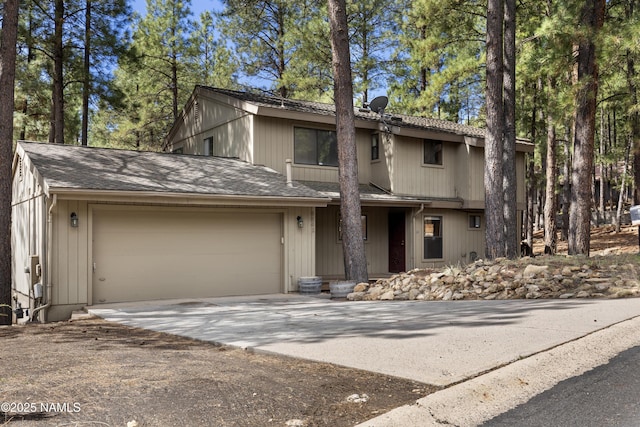 5241 E Mount Pleasant Dr, Flagstaff, AZ 86004 - view of front of property featuring driveway, an attached garage, and roof with shingles