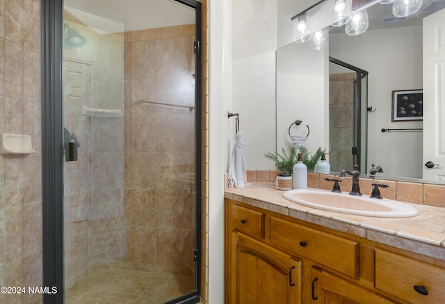 bathroom featuring vanity and a shower with shower door