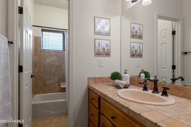 bathroom with tiled shower / bath combo and vanity