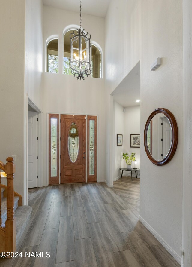 entryway featuring a chandelier and a towering ceiling