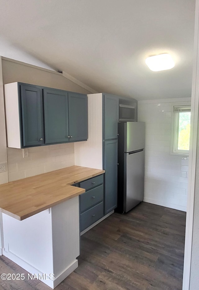 3580 N Jamison Blvd, Flagstaff, AZ 86004 - kitchen featuring freestanding refrigerator, butcher block countertops, dark wood-style flooring, tasteful backsplash, and lofted ceiling