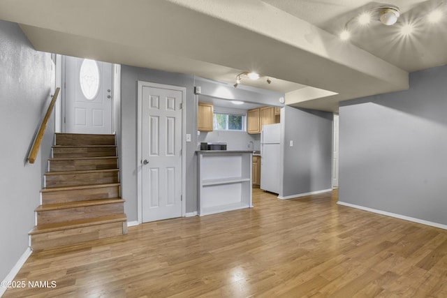 3580 N Jamison Blvd, Flagstaff, AZ 86004 - unfurnished living room with rail lighting, light wood finished floors, and stairway