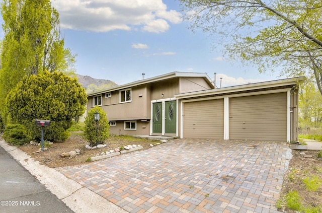 3580 N Jamison Blvd, Flagstaff, AZ 86004 - view of front of house with decorative driveway, an attached garage, and a mountain view