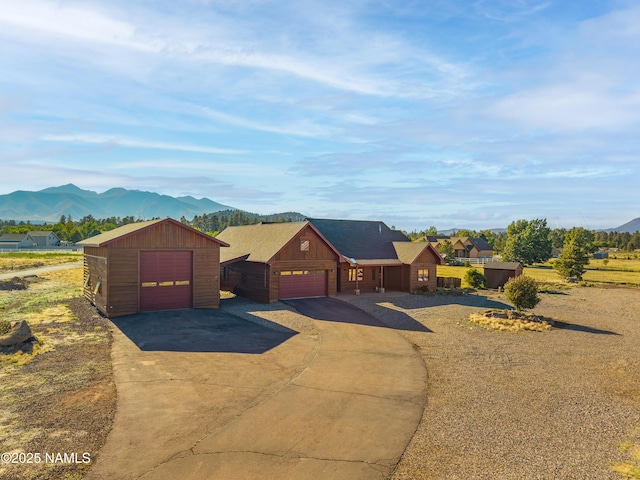 7507 Deville Ln, Flagstaff, AZ 86004 - view of front of home featuring a mountain view, driveway, and a garage