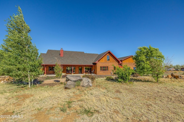 7507 Deville Ln, Flagstaff, AZ 86004 - log-style house with a chimney