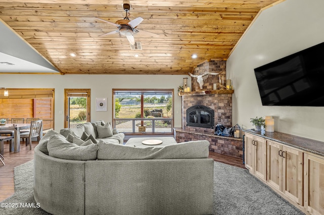 7507 Deville Ln, Flagstaff, AZ 86004 - living area featuring wooden ceiling, a fireplace, vaulted ceiling, ceiling fan, and wood finished floors