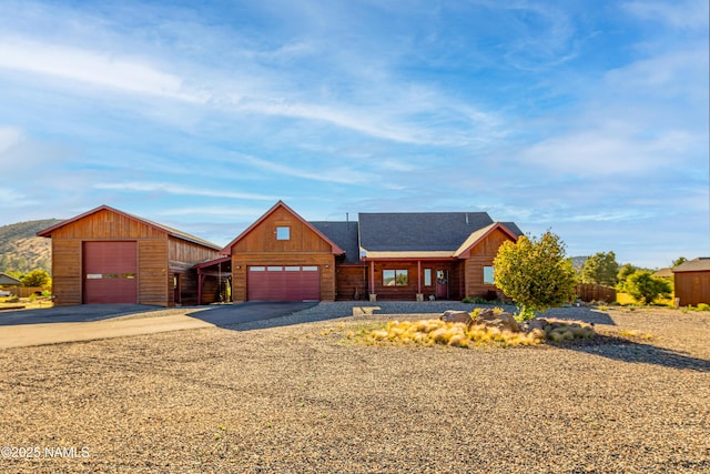 7507 Deville Ln, Flagstaff, AZ 86004 - chalet / cabin featuring asphalt driveway and an attached garage