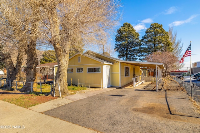 view of front facade with a garage and a carport