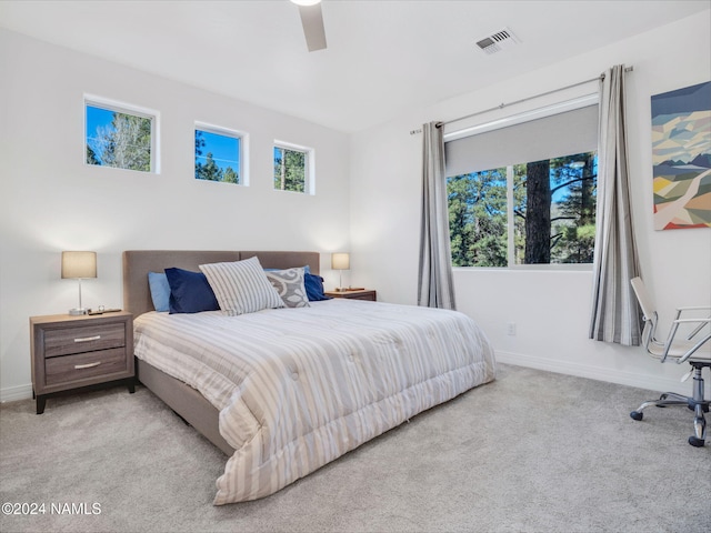 bedroom with ceiling fan and light colored carpet