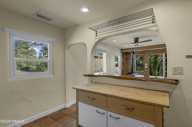 1905 E Mountain View Ave, Flagstaff, AZ 86004 - kitchen with butcher block countertops, plenty of natural light, tile patterned floors, arched walkways, and recessed lighting