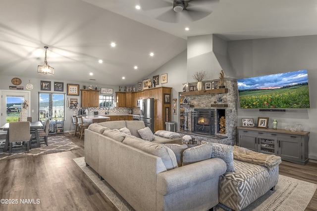 3095 E Pinetree Dr, Williams, AZ 86046 - living room featuring a ceiling fan, dark wood-style flooring, a fireplace, recessed lighting, and high vaulted ceiling
