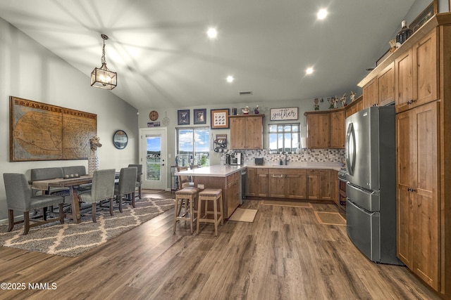 3095 E Pinetree Dr, Williams, AZ 86046 - kitchen featuring appliances with stainless steel finishes, dark wood-style flooring, a breakfast bar, brown cabinets, and recessed lighting