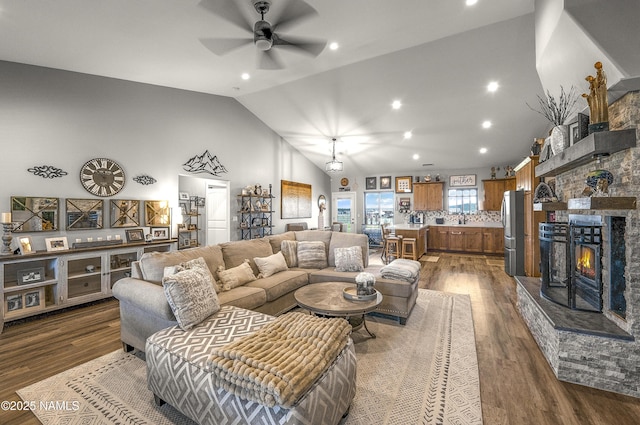 3095 E Pinetree Dr, Williams, AZ 86046 - living area with a ceiling fan, vaulted ceiling, dark wood-style flooring, recessed lighting, and a fireplace