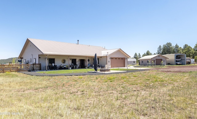 3095 E Pinetree Dr, Williams, AZ 86046 - view of front of house featuring asphalt driveway, a garage, and a metal roof