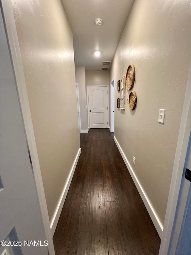 hallway with dark wood-type flooring