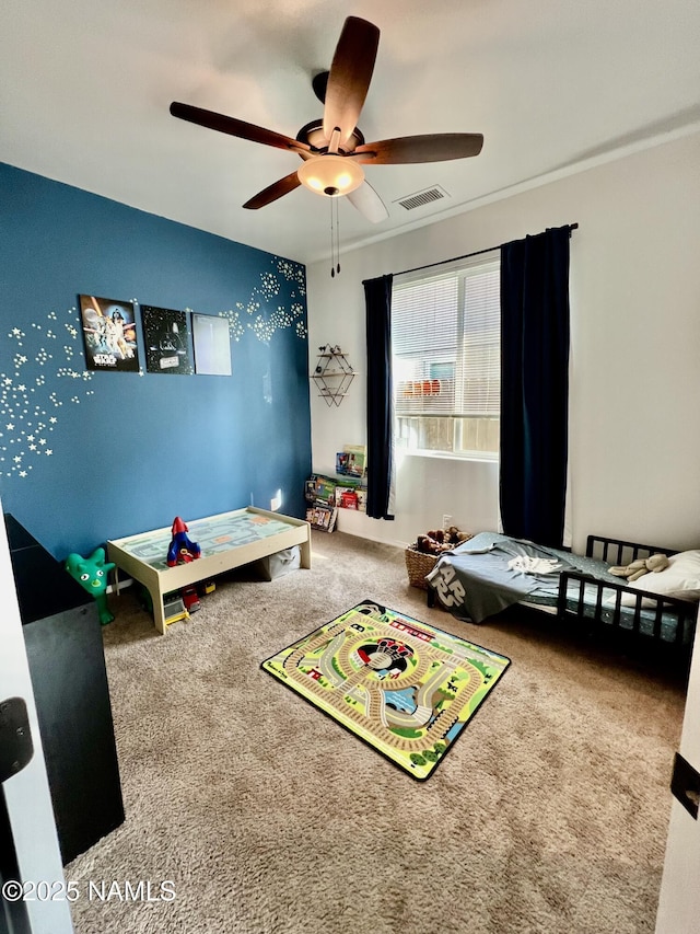 interior space with ceiling fan and carpet flooring