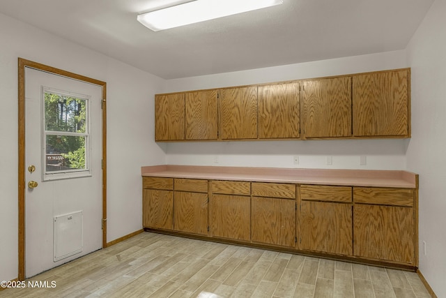 1470 W Melissa Dr, Flagstaff, AZ 86005 - kitchen with light countertops, light wood-style floors, and brown cabinets