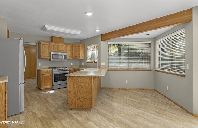 1470 W Melissa Dr, Flagstaff, AZ 86005 - kitchen featuring a peninsula, appliances with stainless steel finishes, light wood-style flooring, light countertops, and recessed lighting