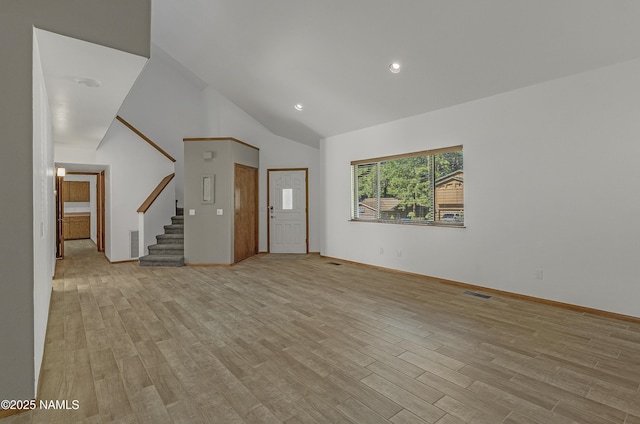 1470 W Melissa Dr, Flagstaff, AZ 86005 - unfurnished living room featuring vaulted ceiling, stairs, light wood-type flooring, and recessed lighting