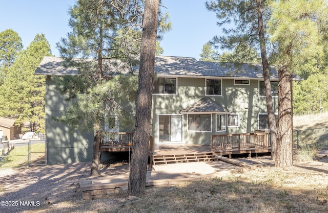 1470 W Melissa Dr, Flagstaff, AZ 86005 - back of property featuring roof with shingles, a wooden deck, and a gate