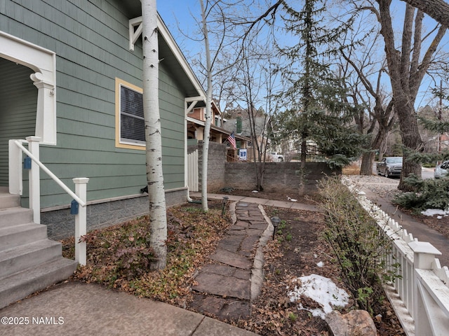 view of side of home with fence