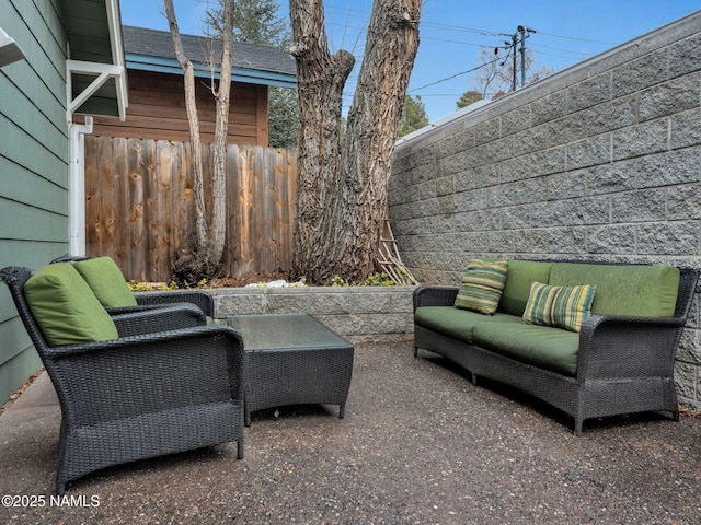 view of patio / terrace featuring outdoor lounge area and fence