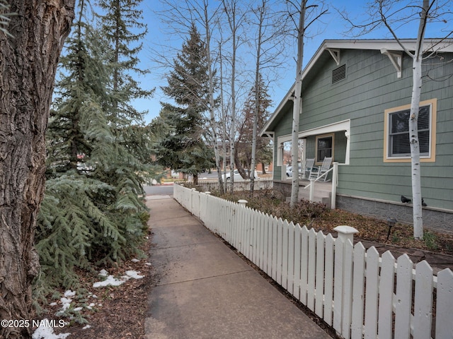 view of side of home featuring a fenced front yard