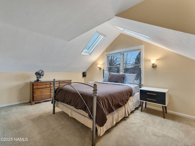 bedroom with baseboards, light colored carpet, and vaulted ceiling with skylight